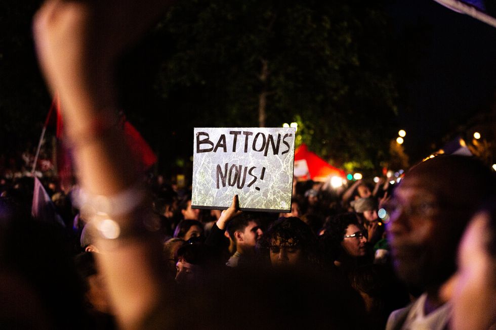 A placard that says ''Let's Fight'' seen amidst the crowd during the demonstration. People packed Place in a demonstration against the far right.