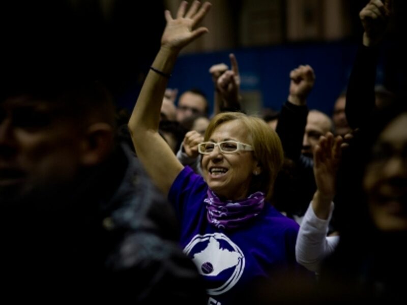 A Podemos supporter watching poll results in Barcelona
