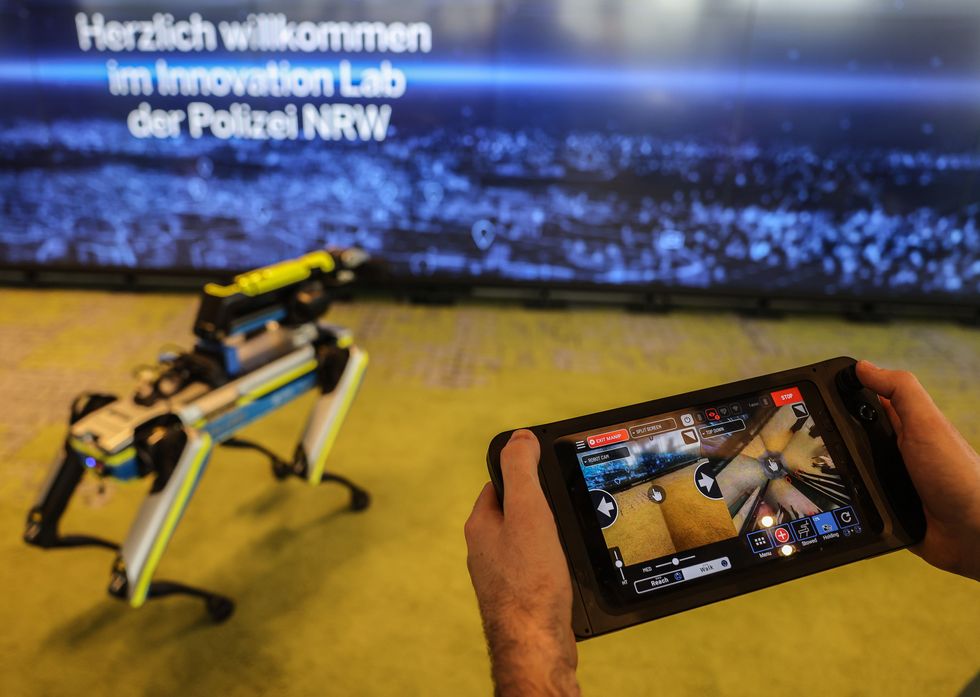 A police officer controls a police robot dog in a training situation at the police Innovation Lab.