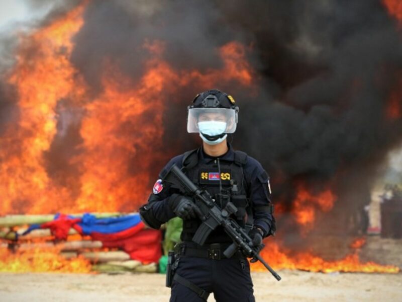 A police officer in Phnom Penh, Cambodia stands guard at a drug burning ceremony