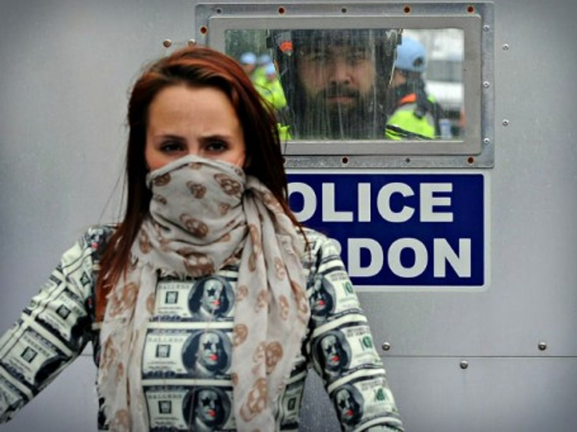 A policeman looks at a masked protester Thursday during the first day of the 2014 NATO Summit held in Newport, Wales.