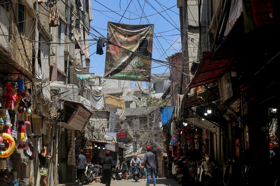 A poster showing Yehya al-Sinwar, the head of Hamas in the Gaza Strip replacing Ismail Haniyeh, hangs in a Palestinian refugee camp in Beirut.