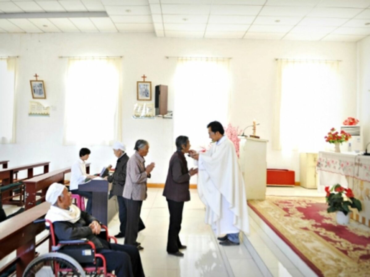 A priest during his daily Mass in Maotuan Village, North West China