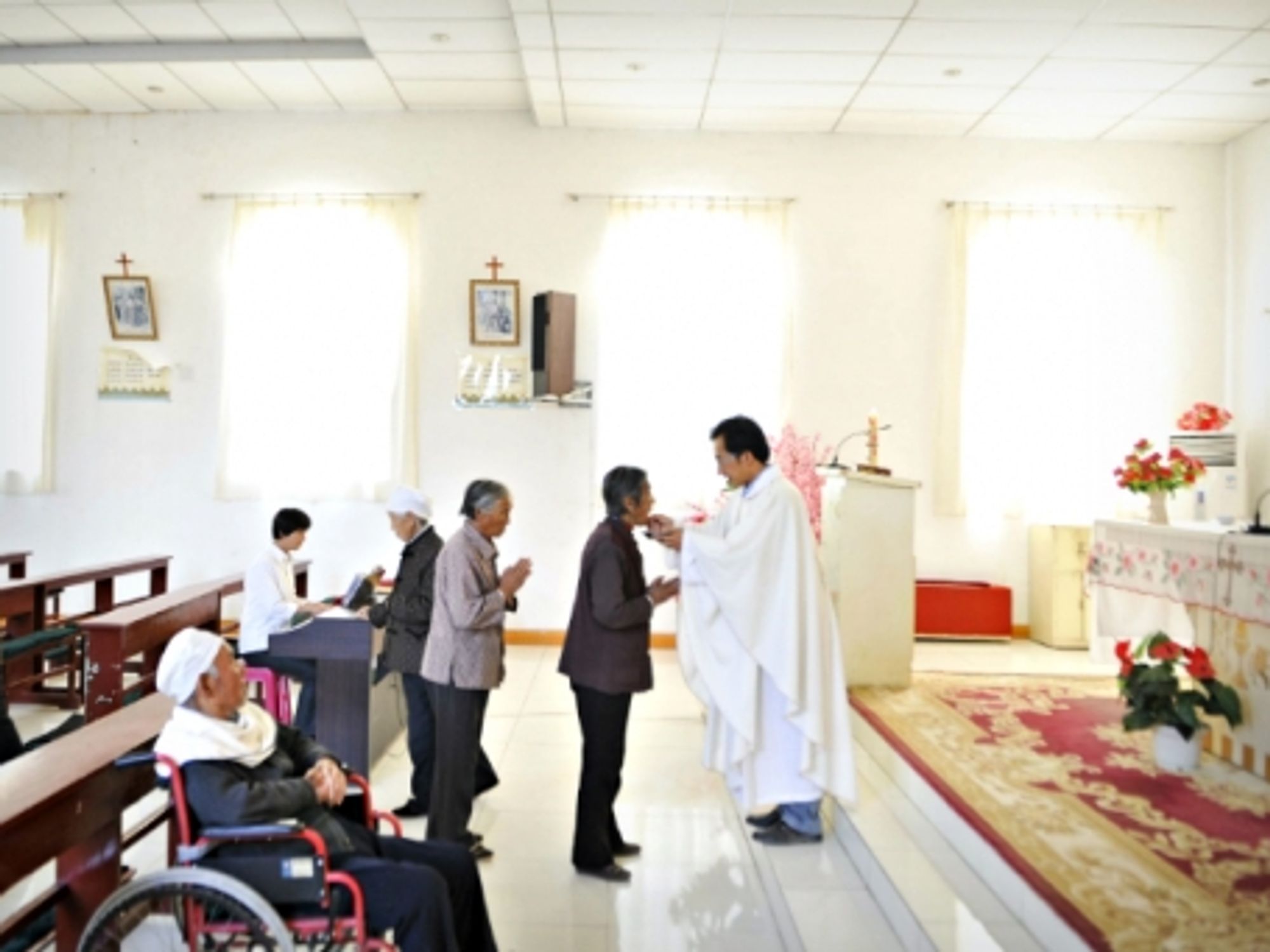 A priest during his daily Mass in Maotuan Village, North West China