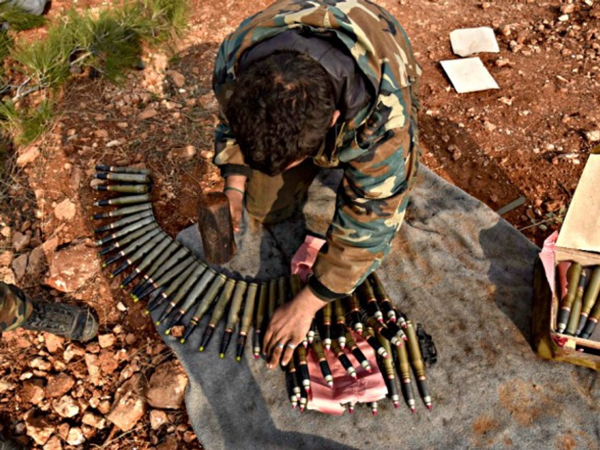 A pro-government Syrian soldier prepares ammunition in Aleppo.