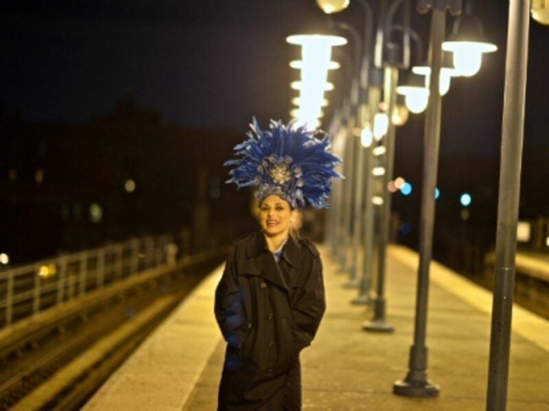 A professional samba dancer at a New York subway stop.