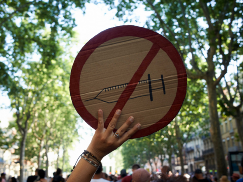 A protester holding up a 'no-vaccine' sign in Paris