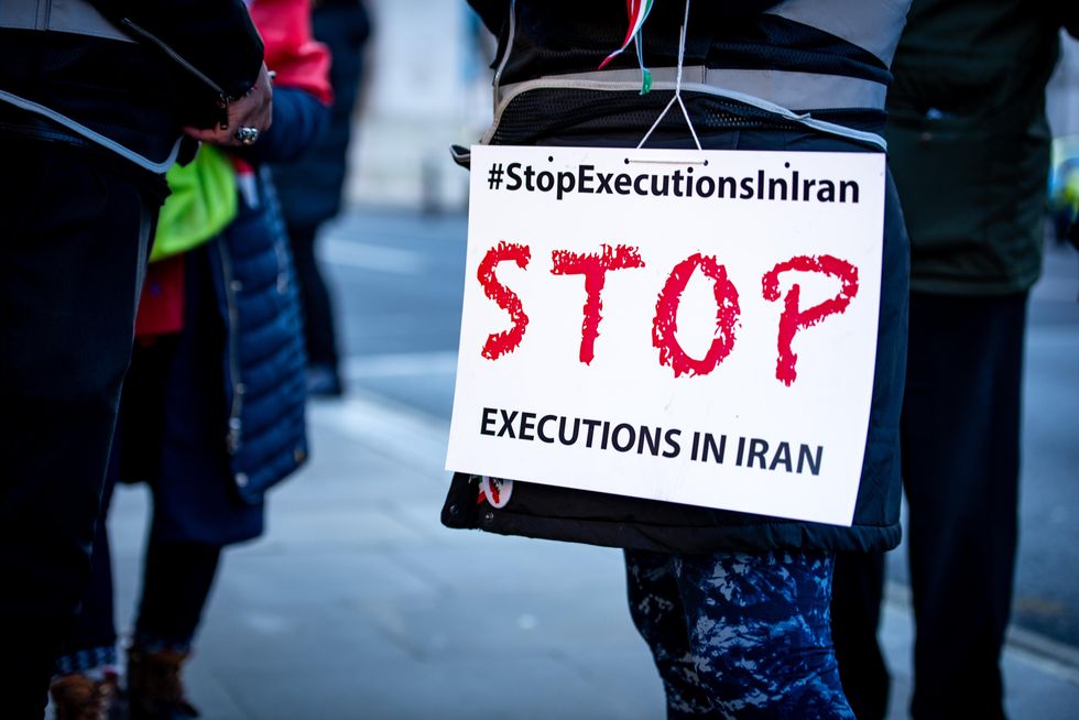 A protester holds a placard during the Support Iran's Revolution! Protest in London.
