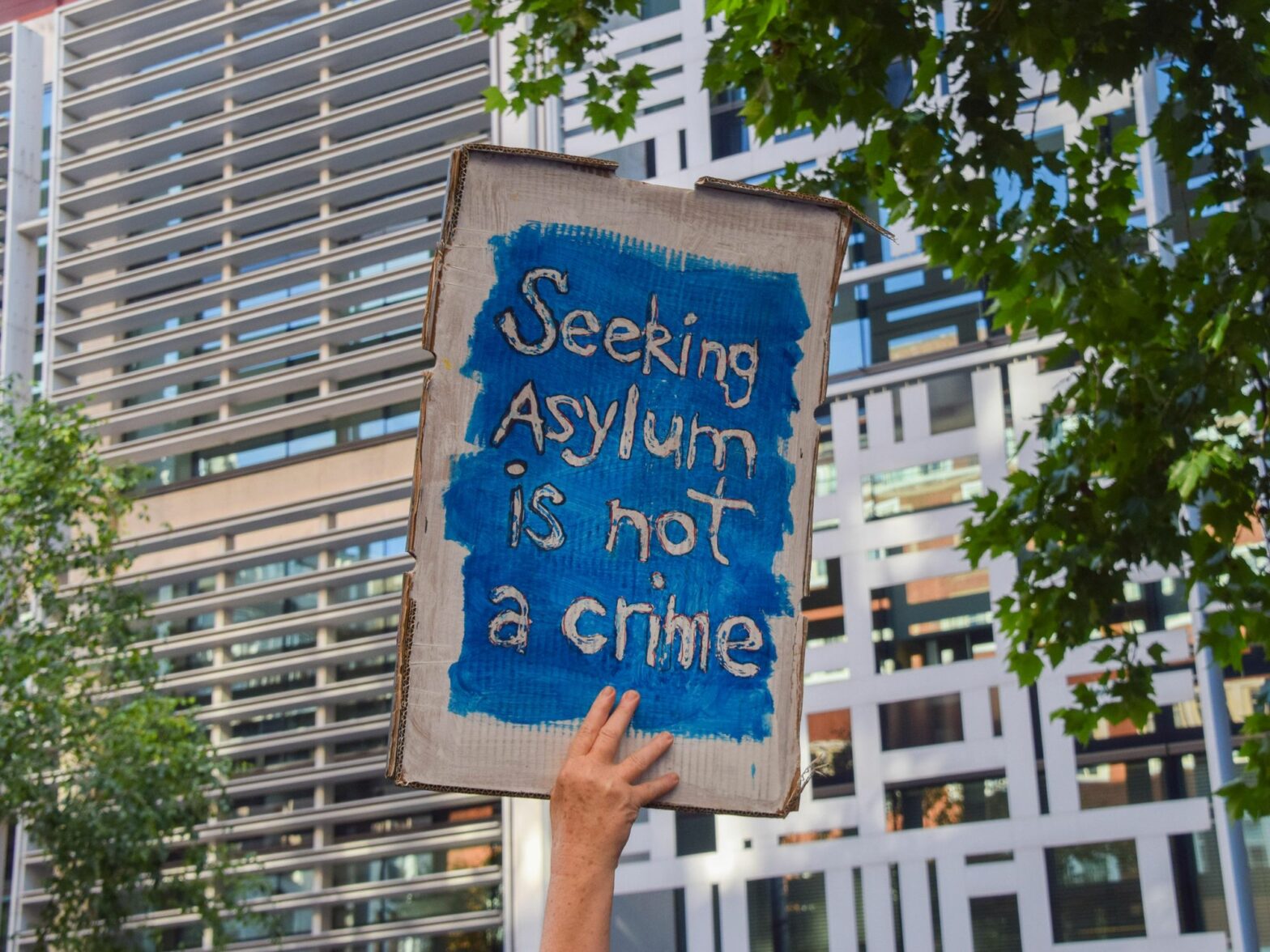 A protester holds a pro-asylum seekers placard during the demonstration.