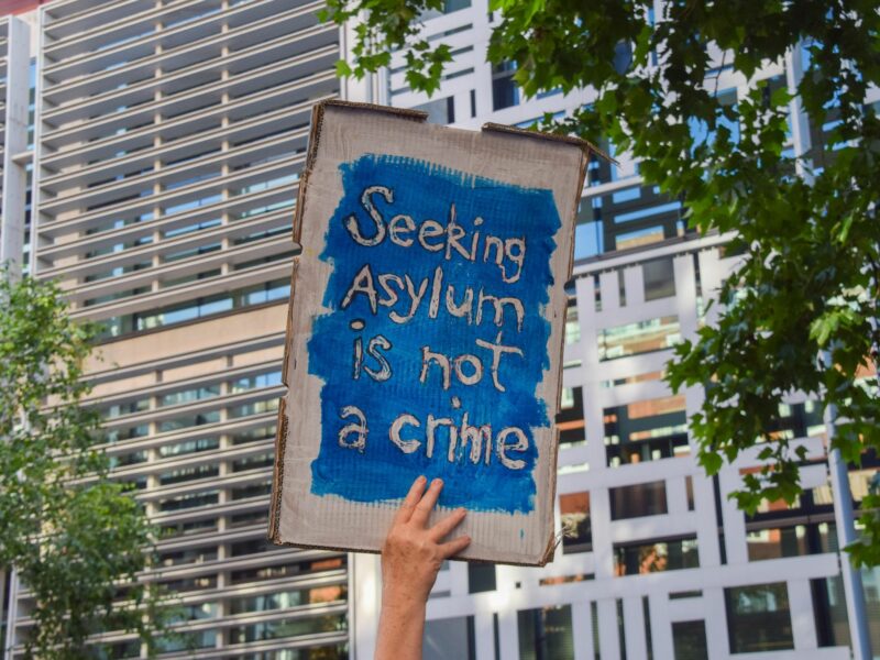 A protester holds a pro-asylum seekers placard during the demonstration.