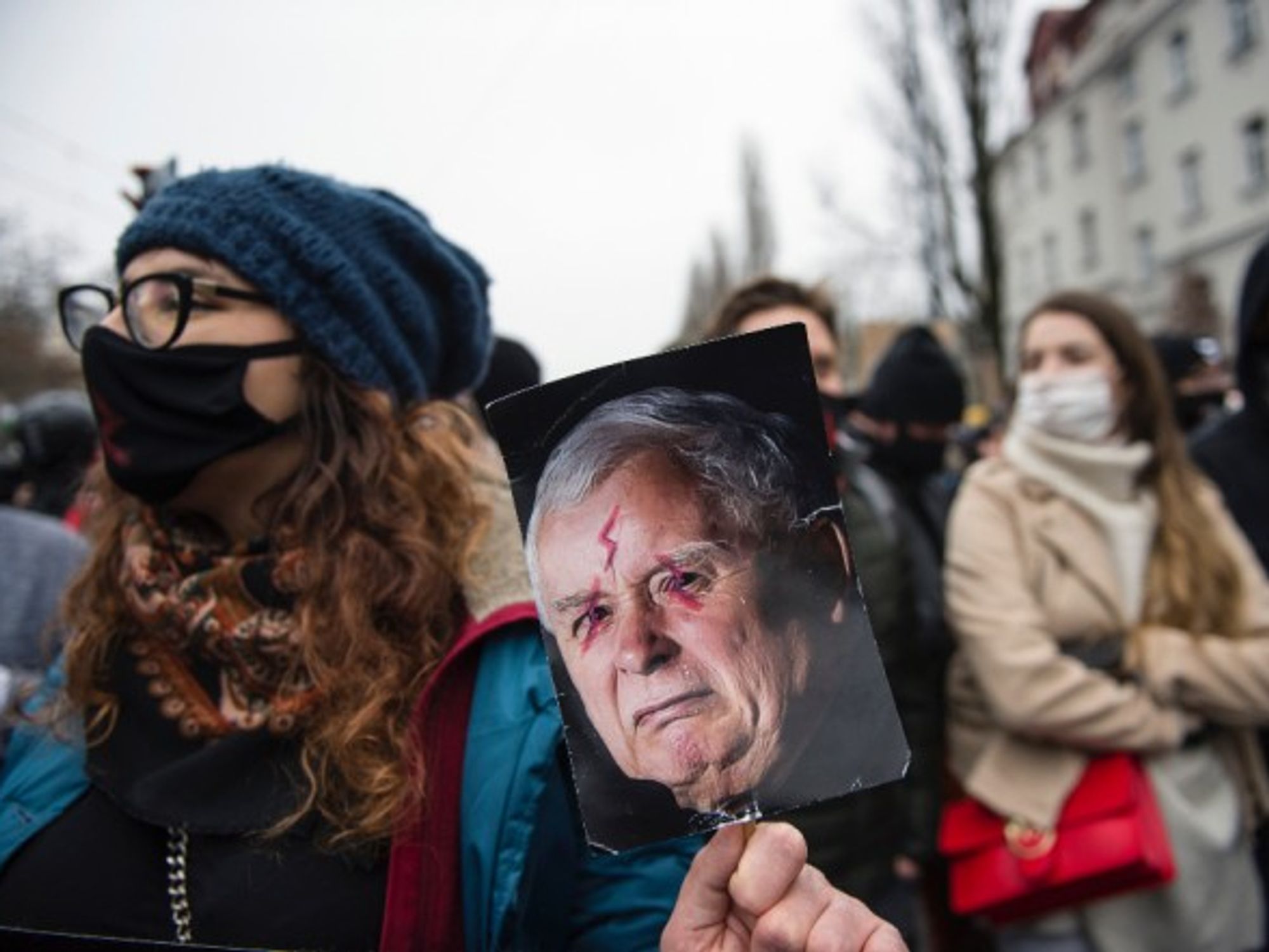 A protester in Warsaw holds a placard with an image of Jaroslaw Kaczynski