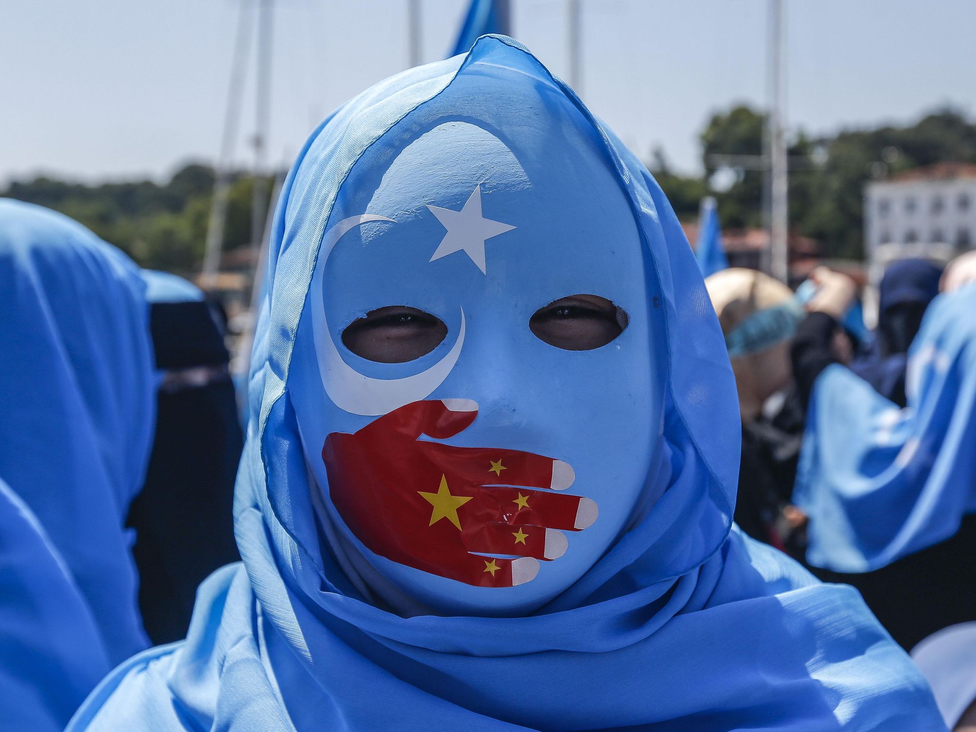 A protester shows his support for the Uyghur community.