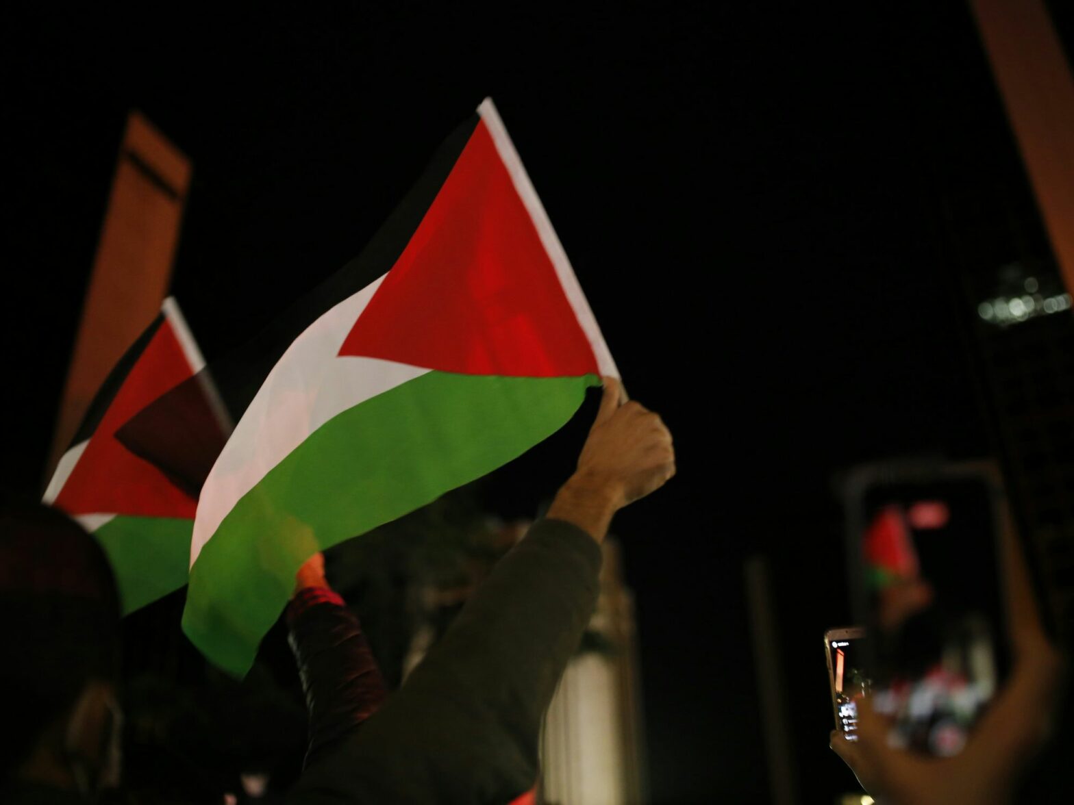 A protester with a Palestinian flag in Istanbul, Turkey.