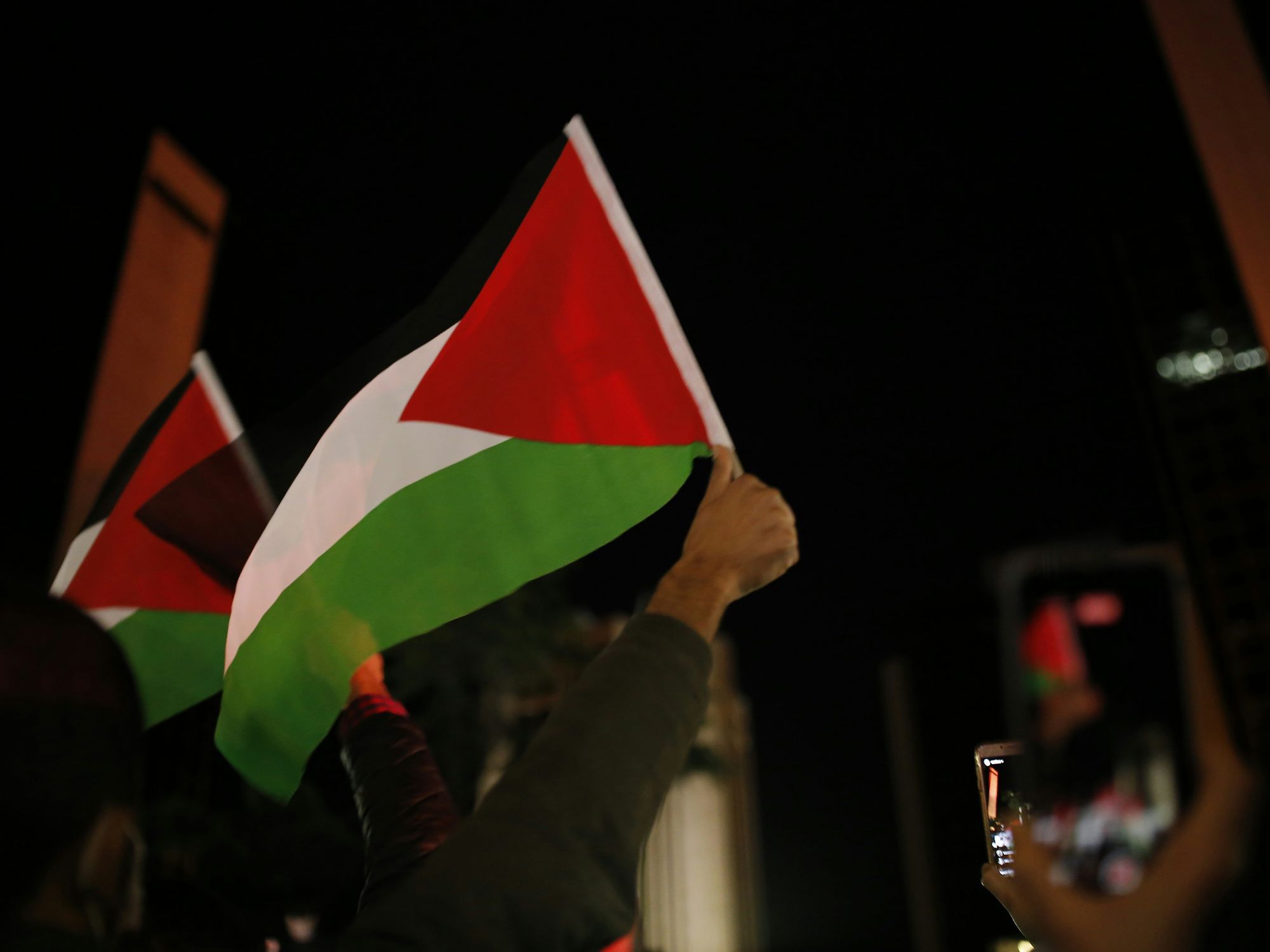 A protester with a Palestinian flag in Istanbul, Turkey.