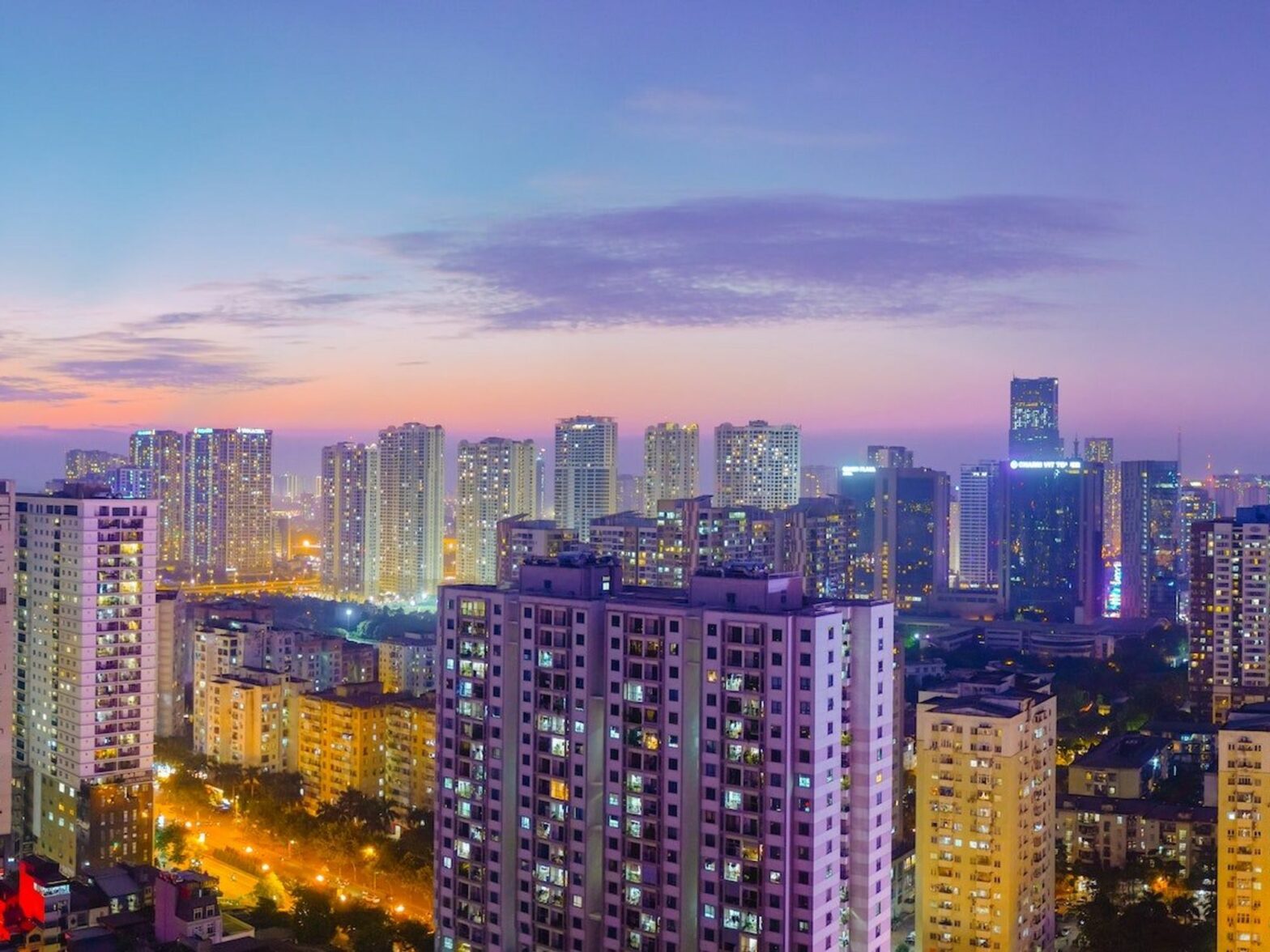A purple tinted city skyline at dusk