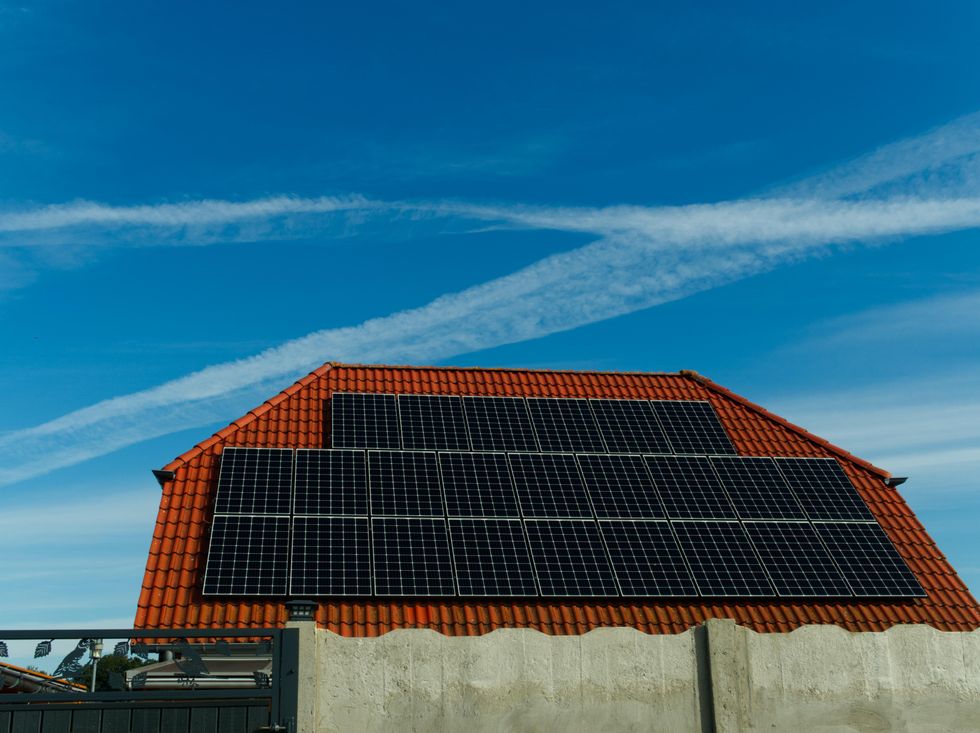 A red-brick house with solar panels.