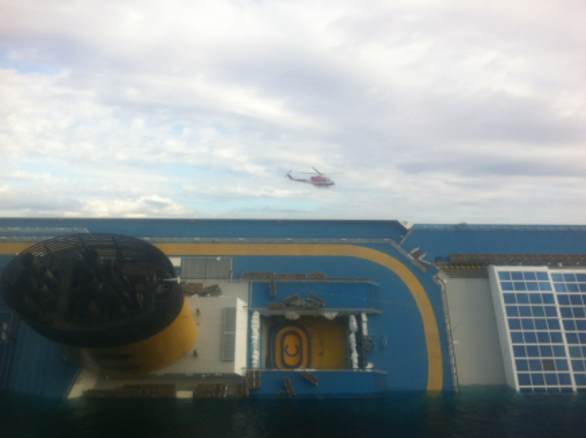 A rescue helicopter circles the sunken Costa Concordia cruise ship (Matthew Price)