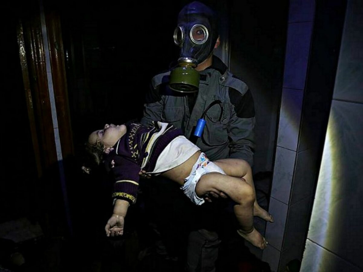 A rescue worker holding a child after the alleged chemical attack in Douma