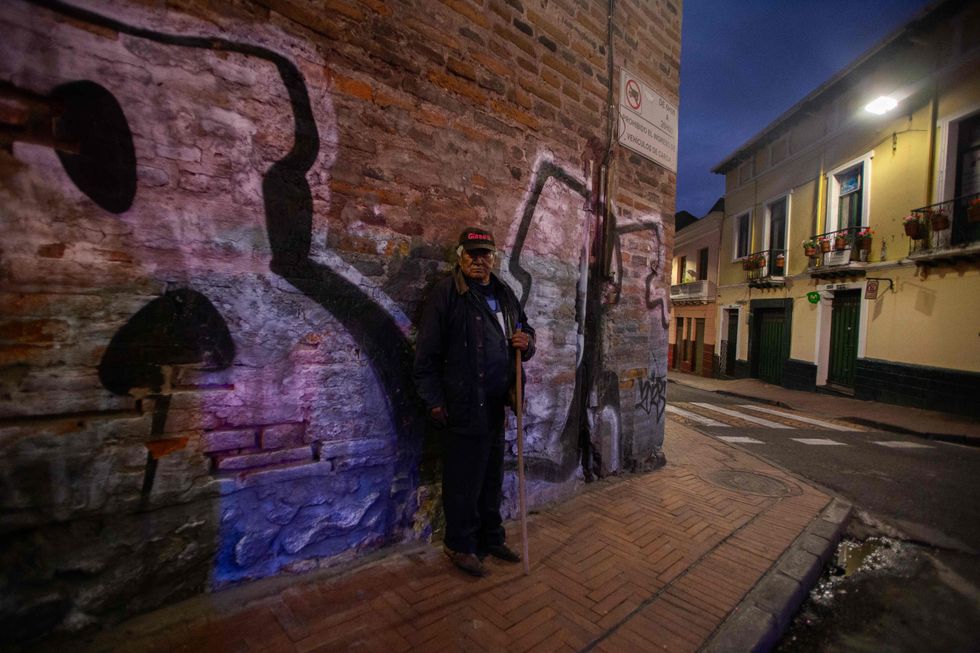 A resident observes patrols and searches by Ecuadorian police in the historic center of the city.