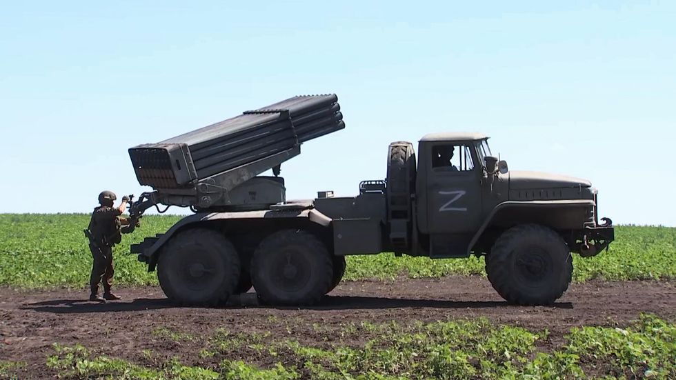A Russian artillery unit serviceman operates a BM-21