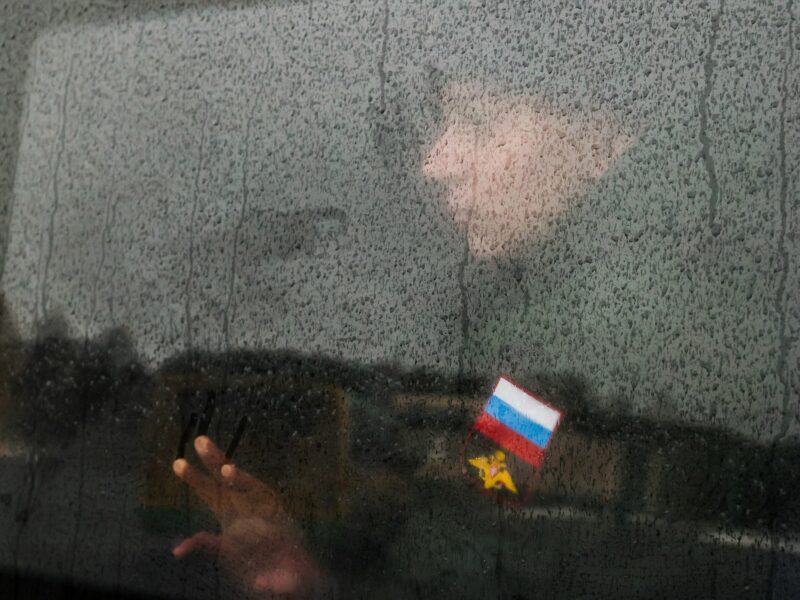 A Russian conscript looking through a train window