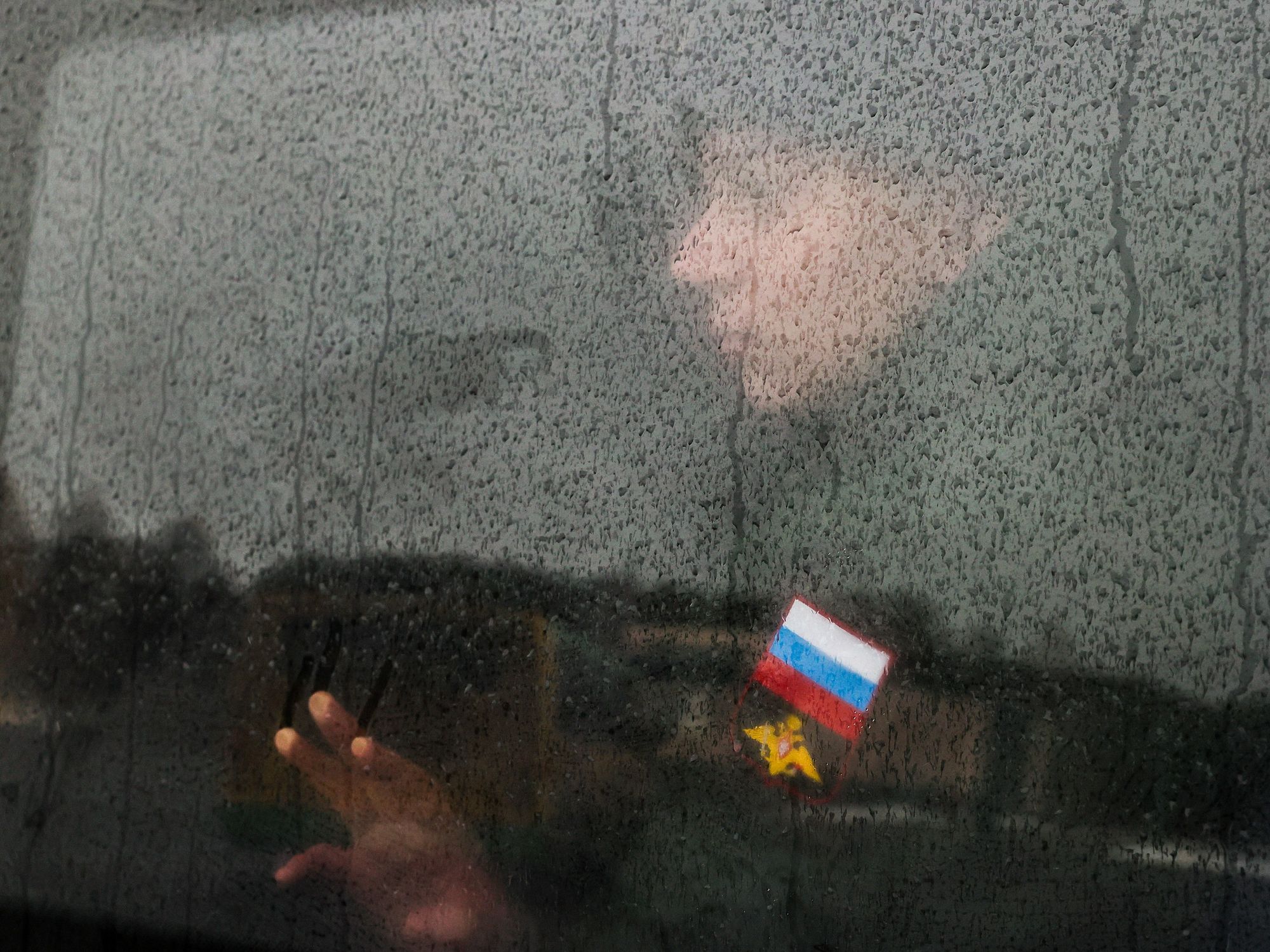 A Russian conscript looking through a train window