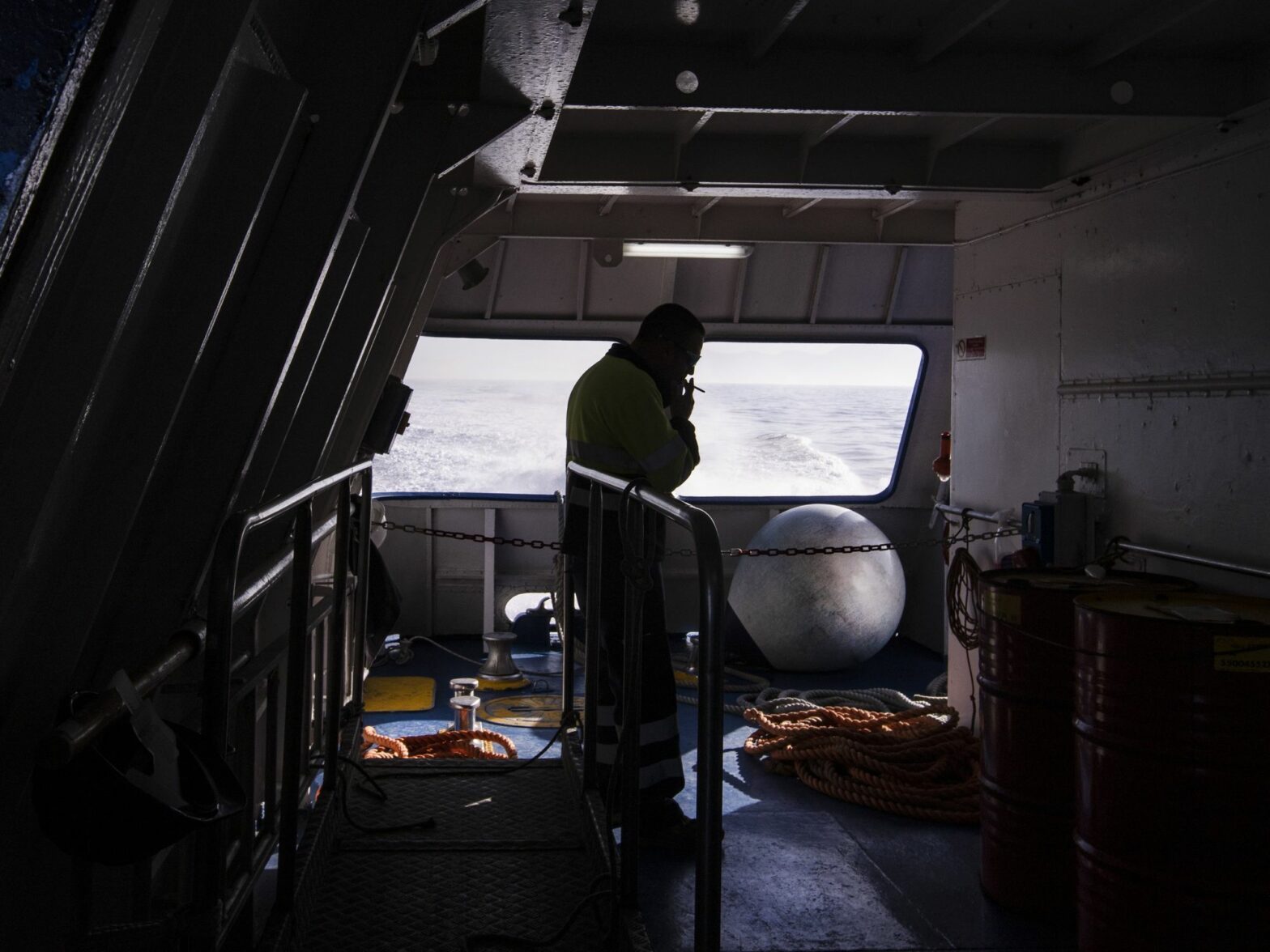 A sailor smokes a cigarette on the hydrofoil Procida