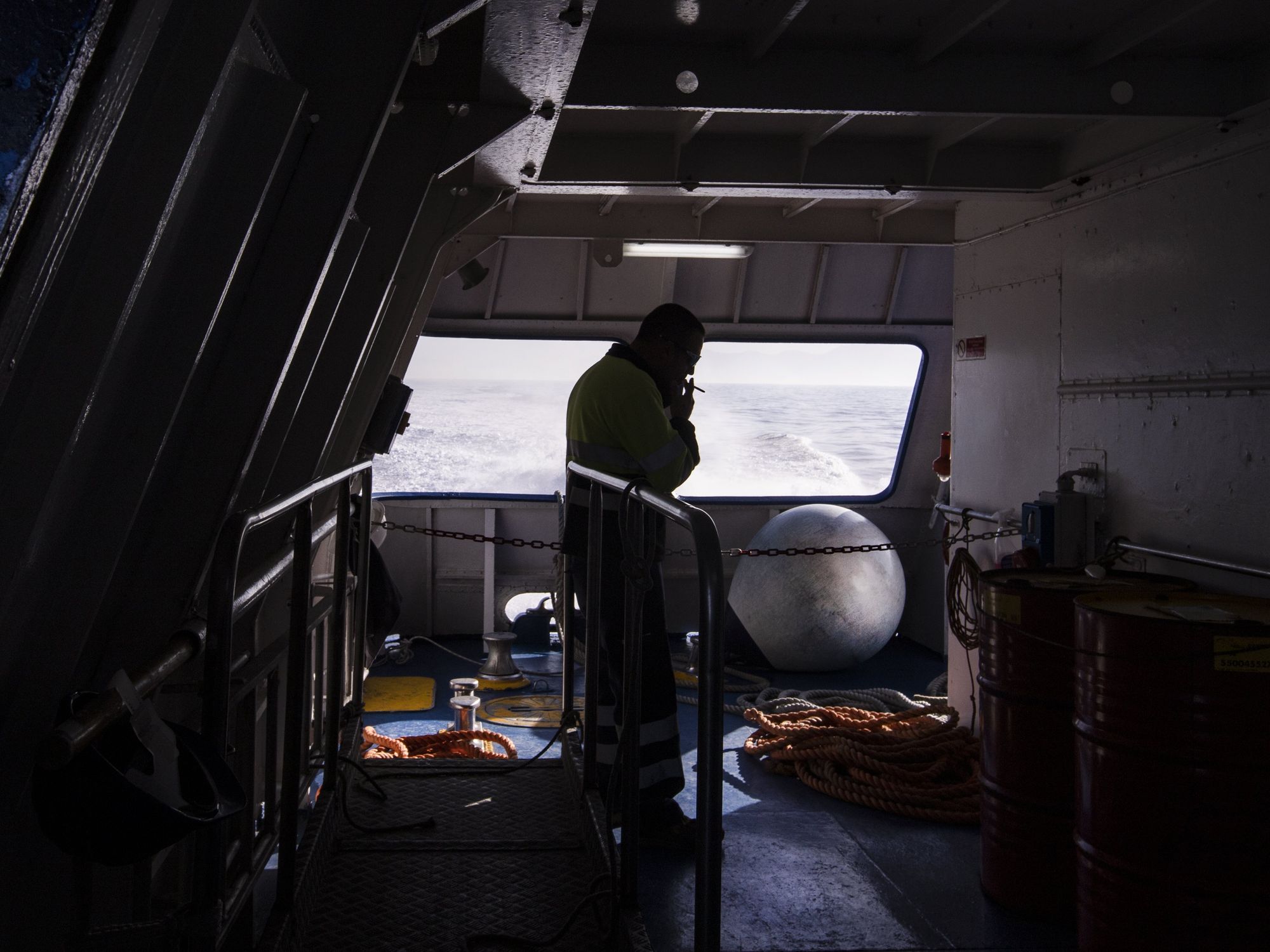 A sailor smokes a cigarette on the hydrofoil Procida