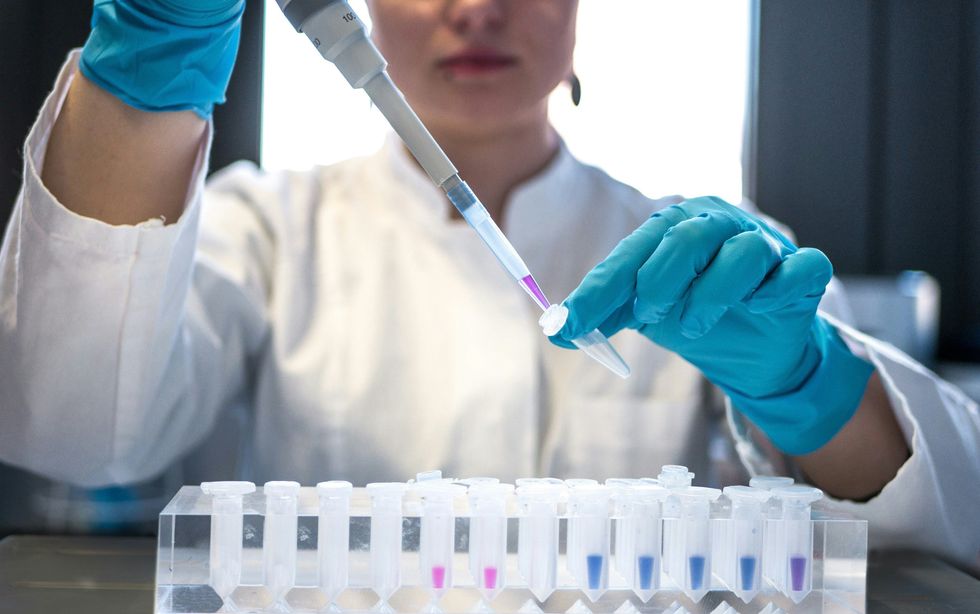 A scientist manipulating test tubes