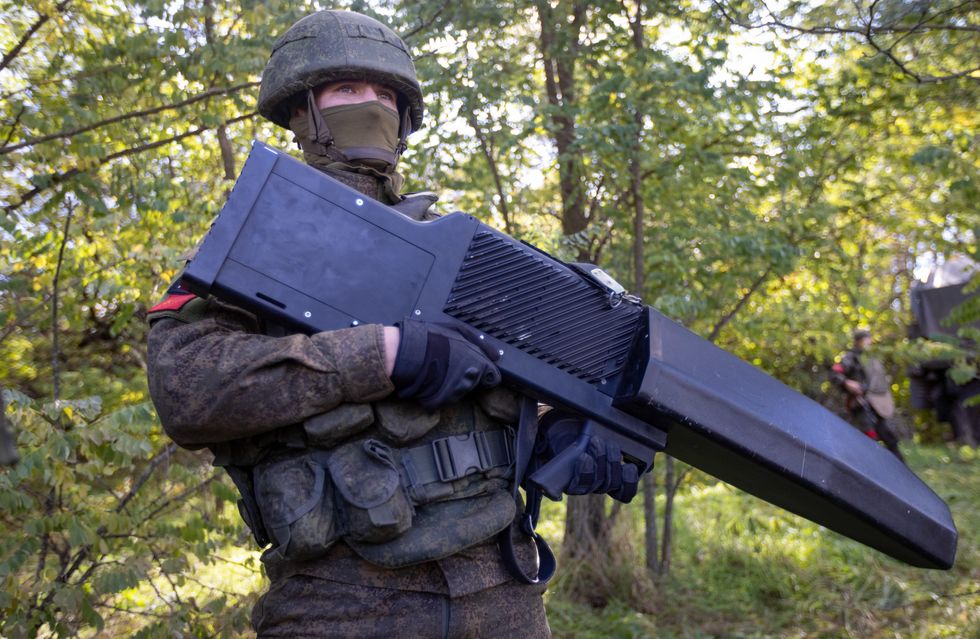 A serviceman uses a Garpun handheld anti-drone weapon