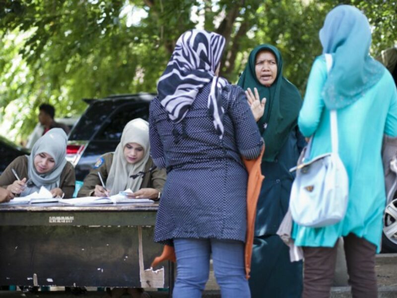 A Sharia policewoman (second from right) in Banda Aceh