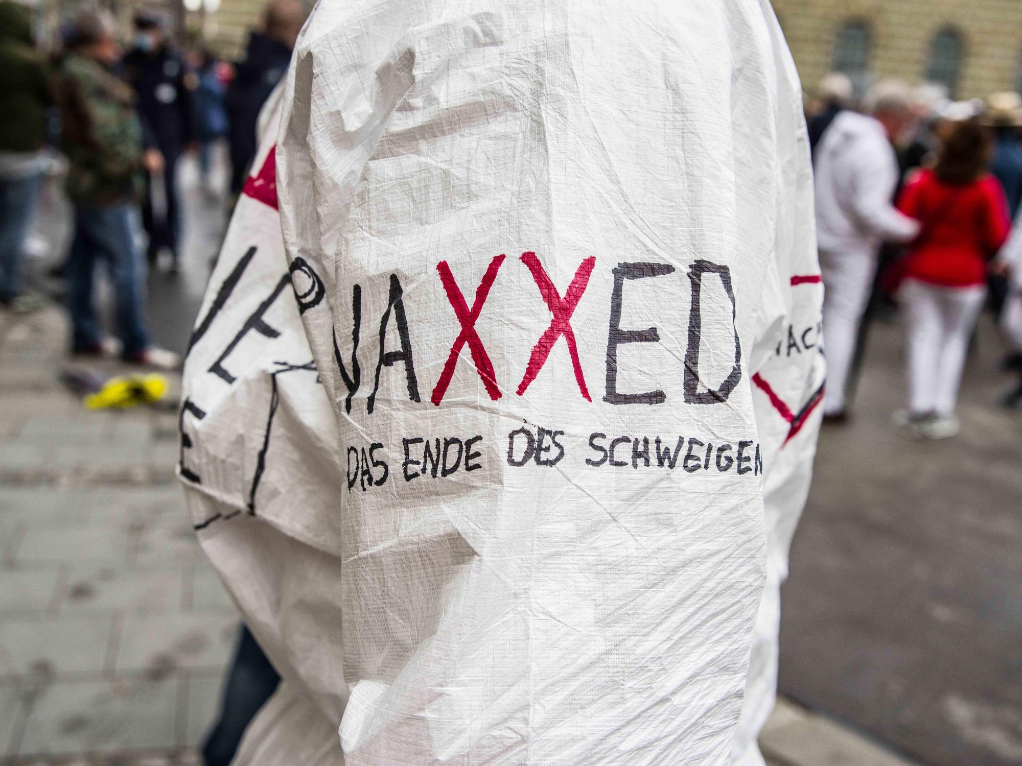 A sheet at a protest that says VAXXED