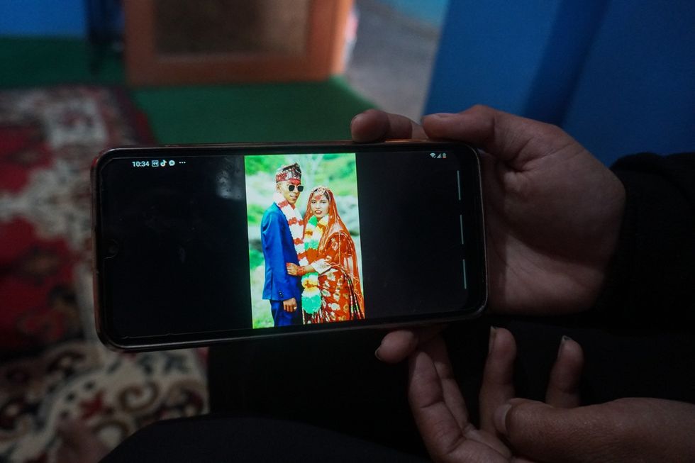 A smartphone displaying a wedding photo.