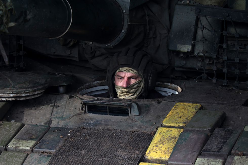 A soldier of the 3rd Independent Tank Iron Brigade is in the hatch of a tank while on combat duty, Kharkiv region, northeastern Ukraine.