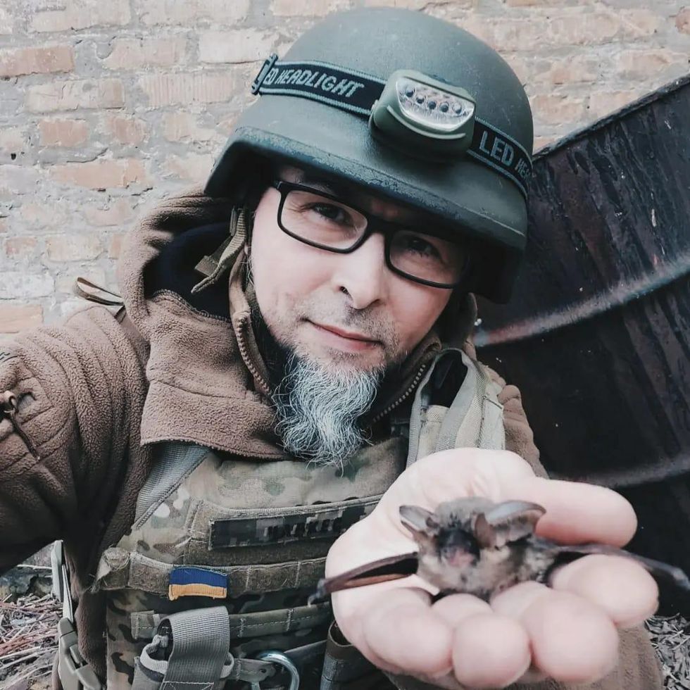 A solider from the Ukraine army holding a bat