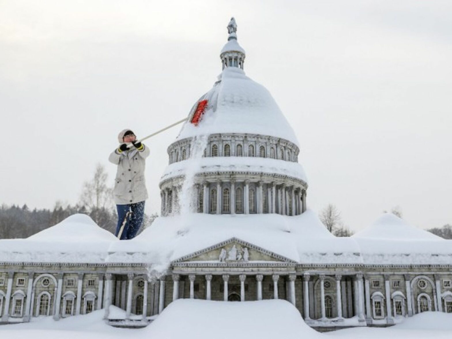 A staff member clears snow from a miniature replica of the U.S. Capitol in Miniwelt, a tourist attraction in Lichtenstein, eastern Germany.