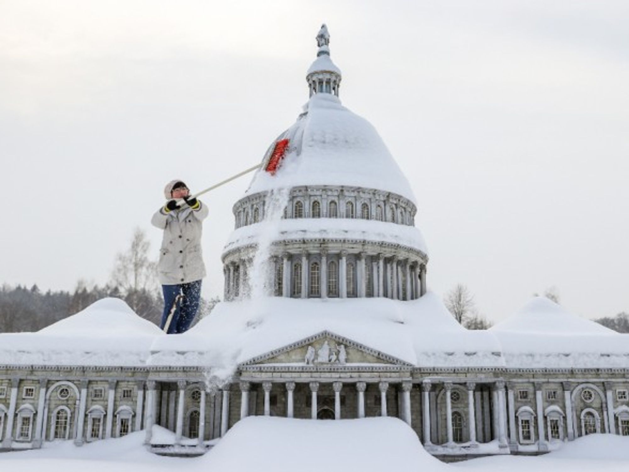 A staff member clears snow from a miniature replica of the U.S. Capitol in Miniwelt, a tourist attraction in Lichtenstein, eastern Germany.