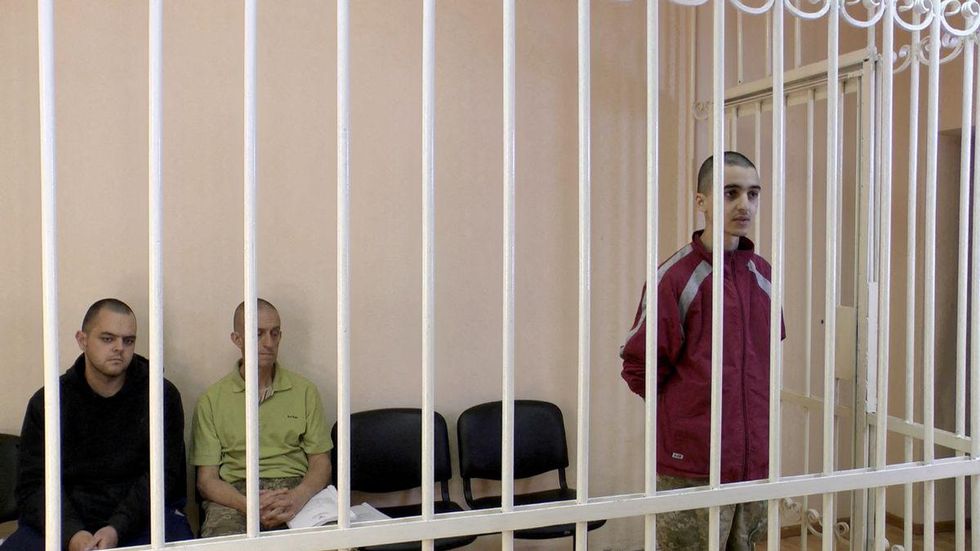 A still image, taken from footage of the Supreme Court of the self-proclaimed Donetsk People's Republic, shows Britons Aiden Aslin, Shaun Pinner and Moroccan Brahim Saadoun