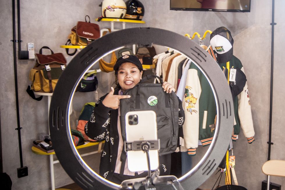 A store worker shows off products on TikTok livestreaming.