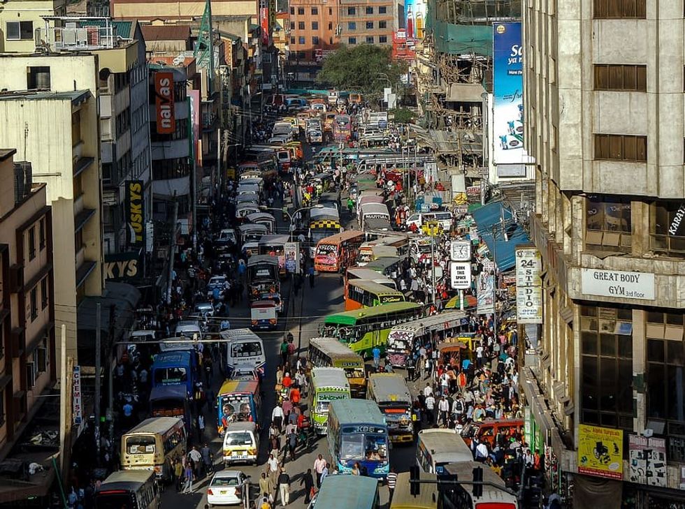 A street filled with matatu and pedestrians in Nairobi, Kenya