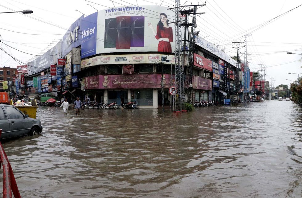 A street in Lahore, Pakistan is completely flooded with people walking through it on their commute to work