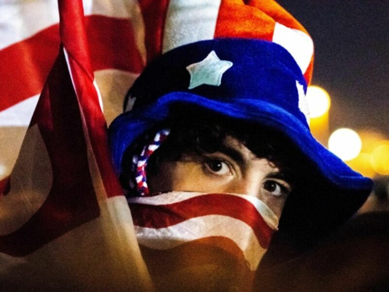 A supporter of Joseph Biden watching him give his first address as president