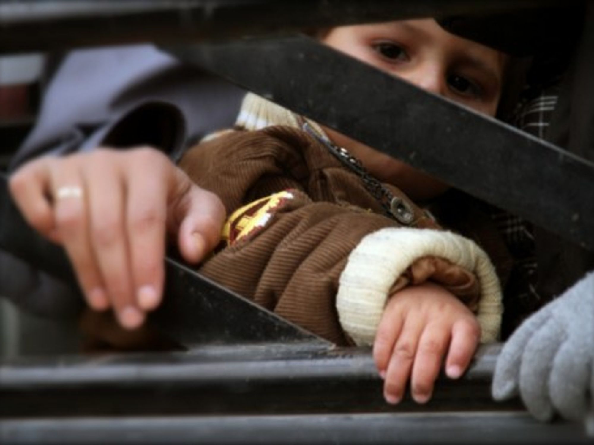 A Syrian child comes back into al-Moadamiya, a district on the outskirts of Damascus that has been besieged by the government troops for months, in Syria, March 2, 2014.