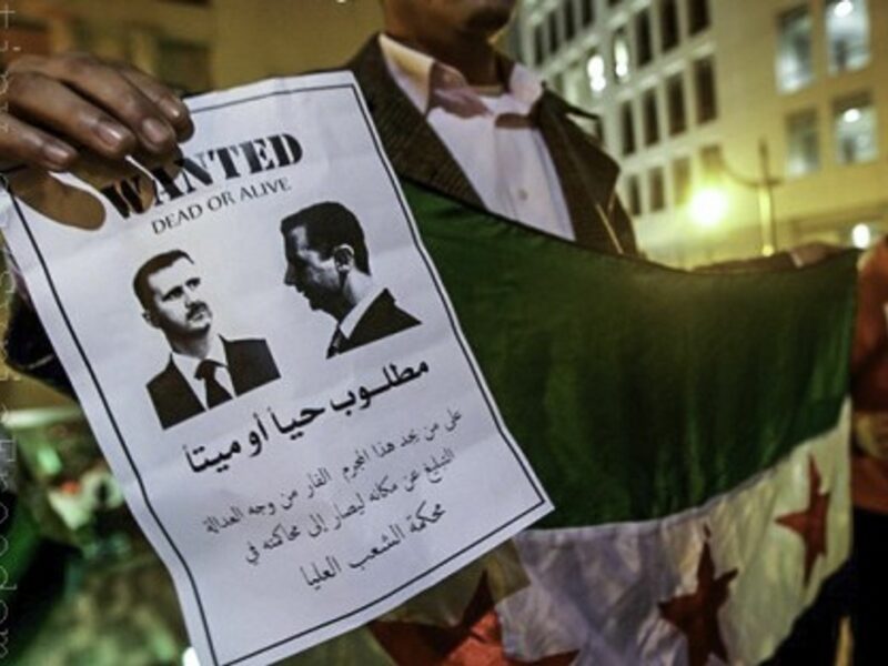 A Syrian Kurdish man protests against Bashar al-Assad