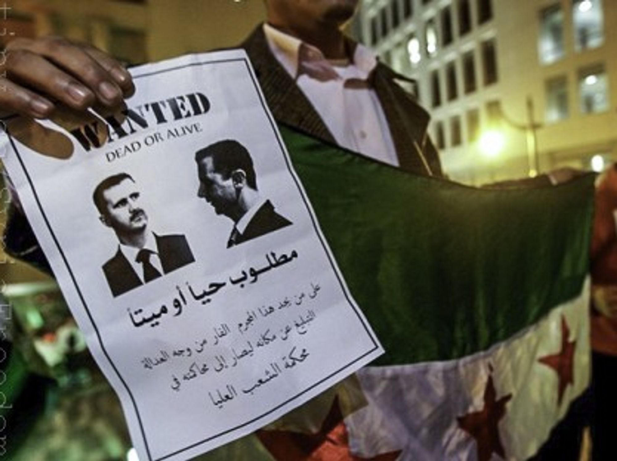 A Syrian Kurdish man protests against Bashar al-Assad