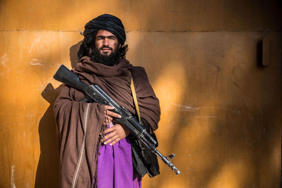 A Taliban fighter poses with his weapon