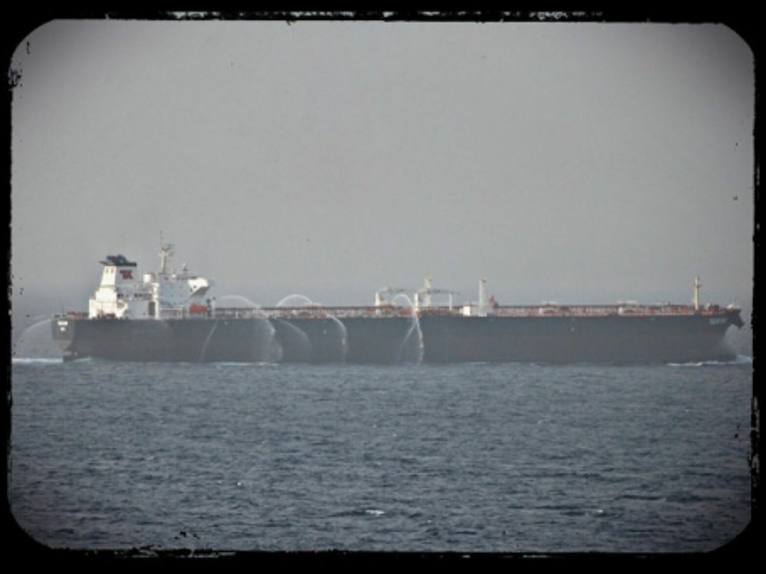 A tanker in the Gulf of Aden uses fire hoses to keep pirates away.
