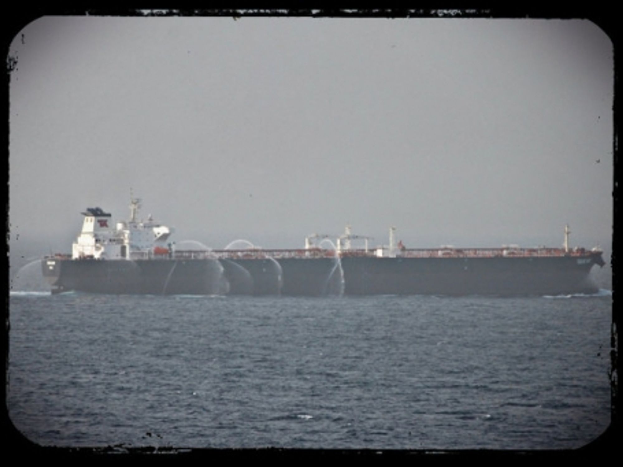 A tanker in the Gulf of Aden uses fire hoses to keep pirates away.