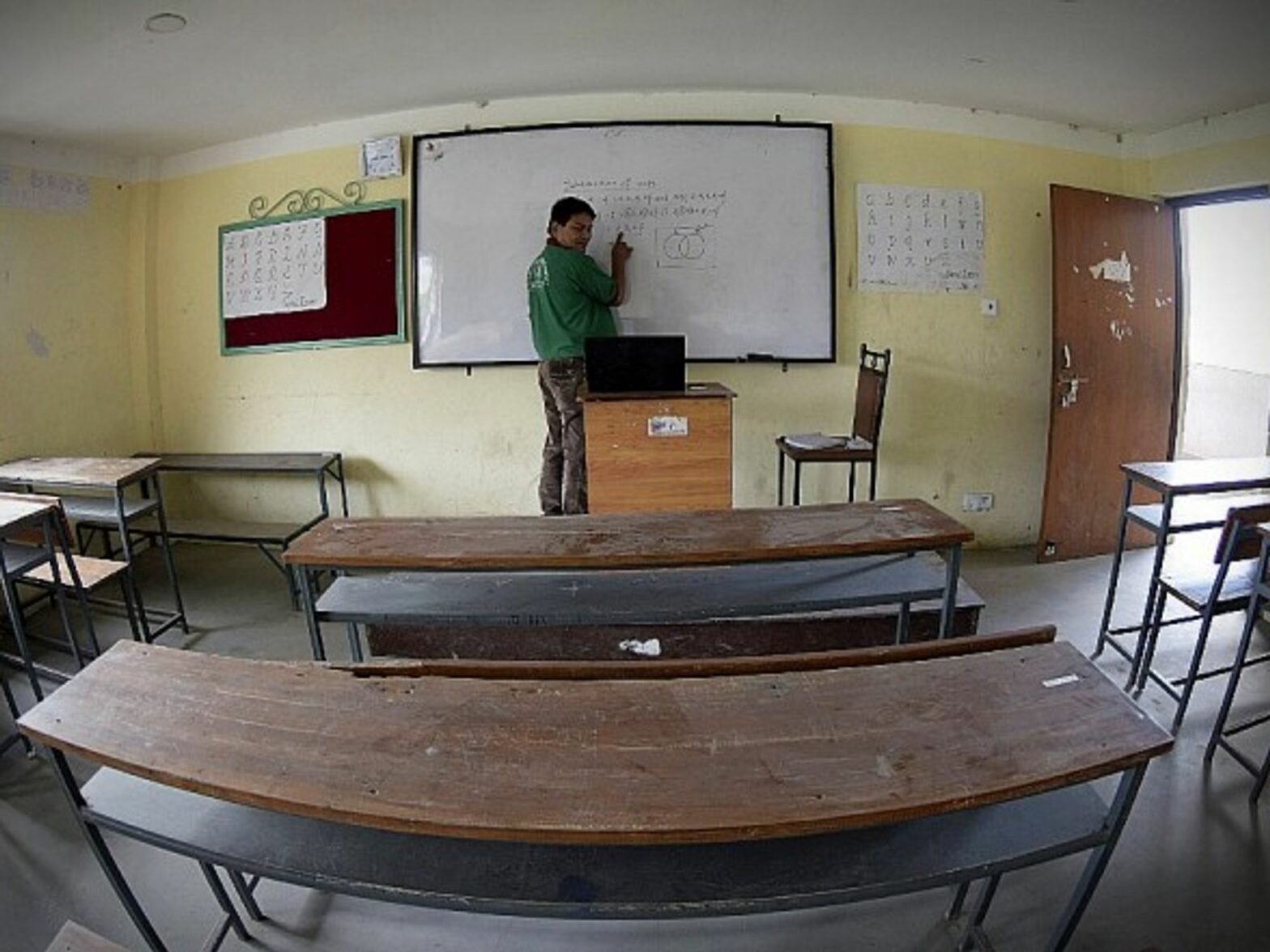A teacher giving an online class in an empty school in Lalitpur, Nepal