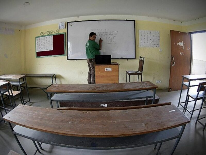 A teacher giving an online class in an empty school in Lalitpur, Nepal
